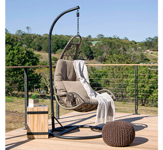 Brown hanging chair on outside deck in bush setting